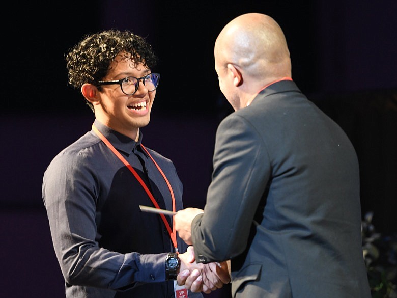 Santiago Avila, of Highland Academy, receives his Overall Comm Contest Award of $1,000 from Jason Merryman, VP of Enrollment Management /©CTFP