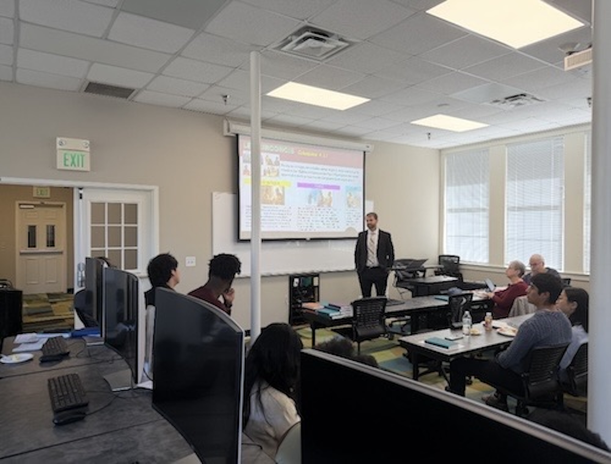 Group attending a Sabbath School discussion in a classroom.