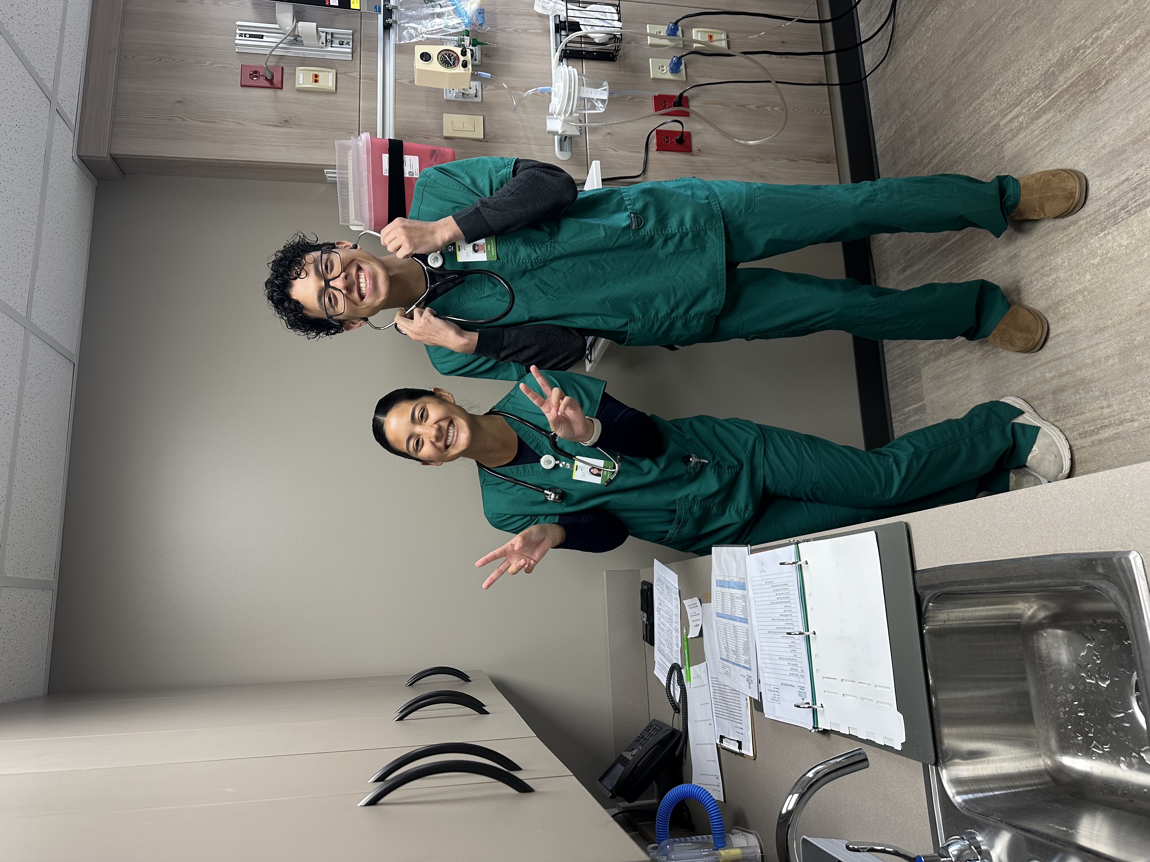 Two students pose for the camera in the simulation lab.
