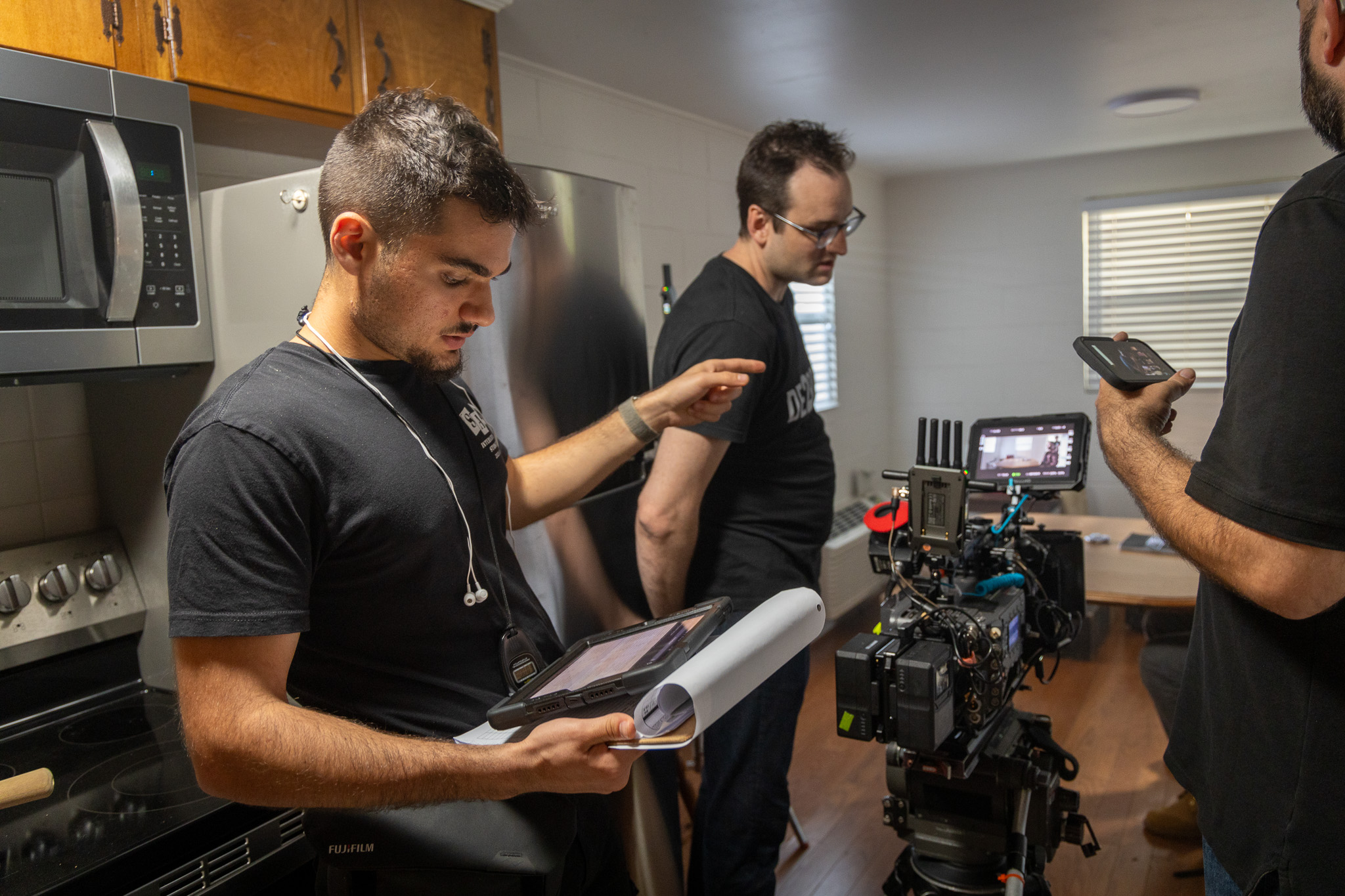 Production crew members collaborate together on set.