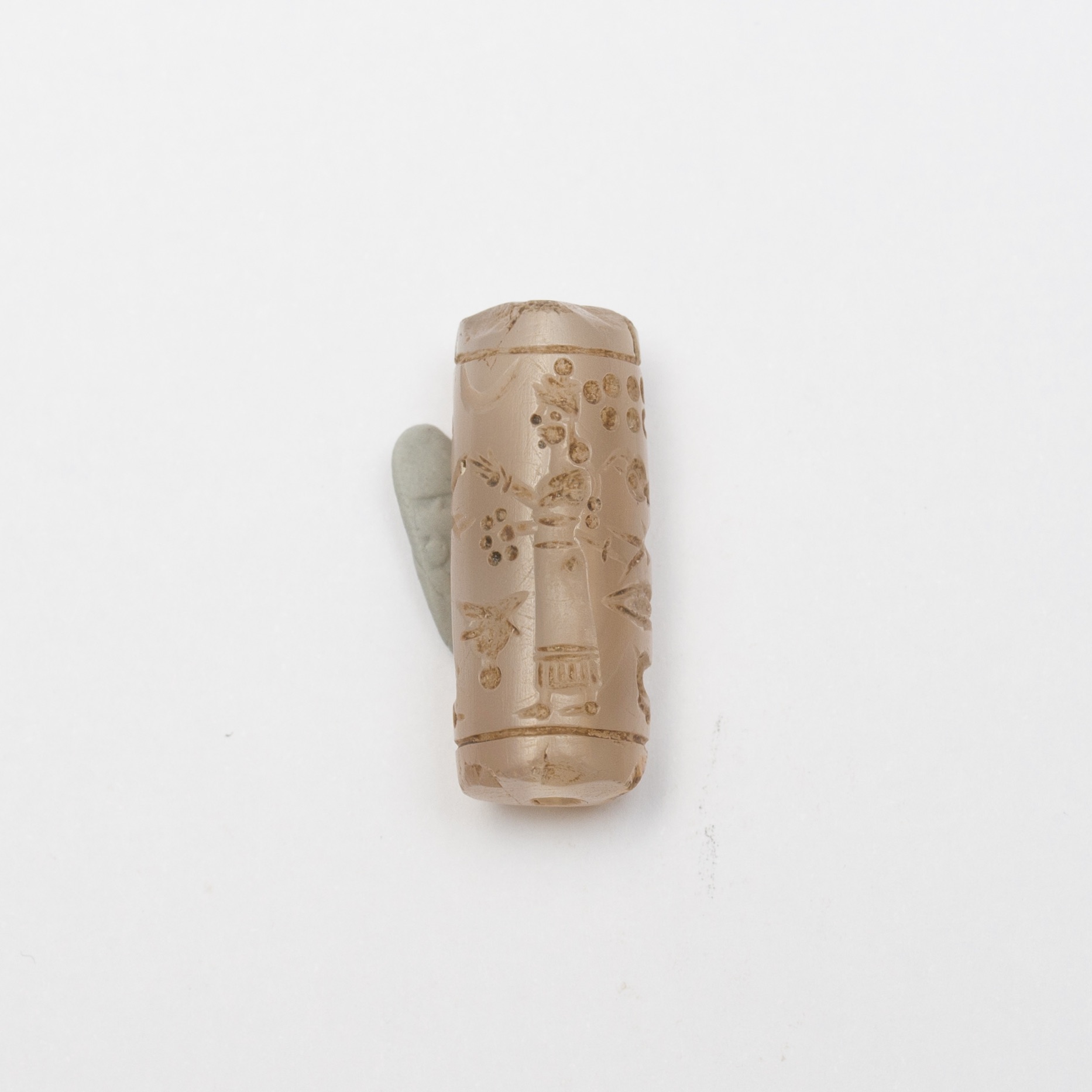 a cylinder seal made out of a pink precious stone