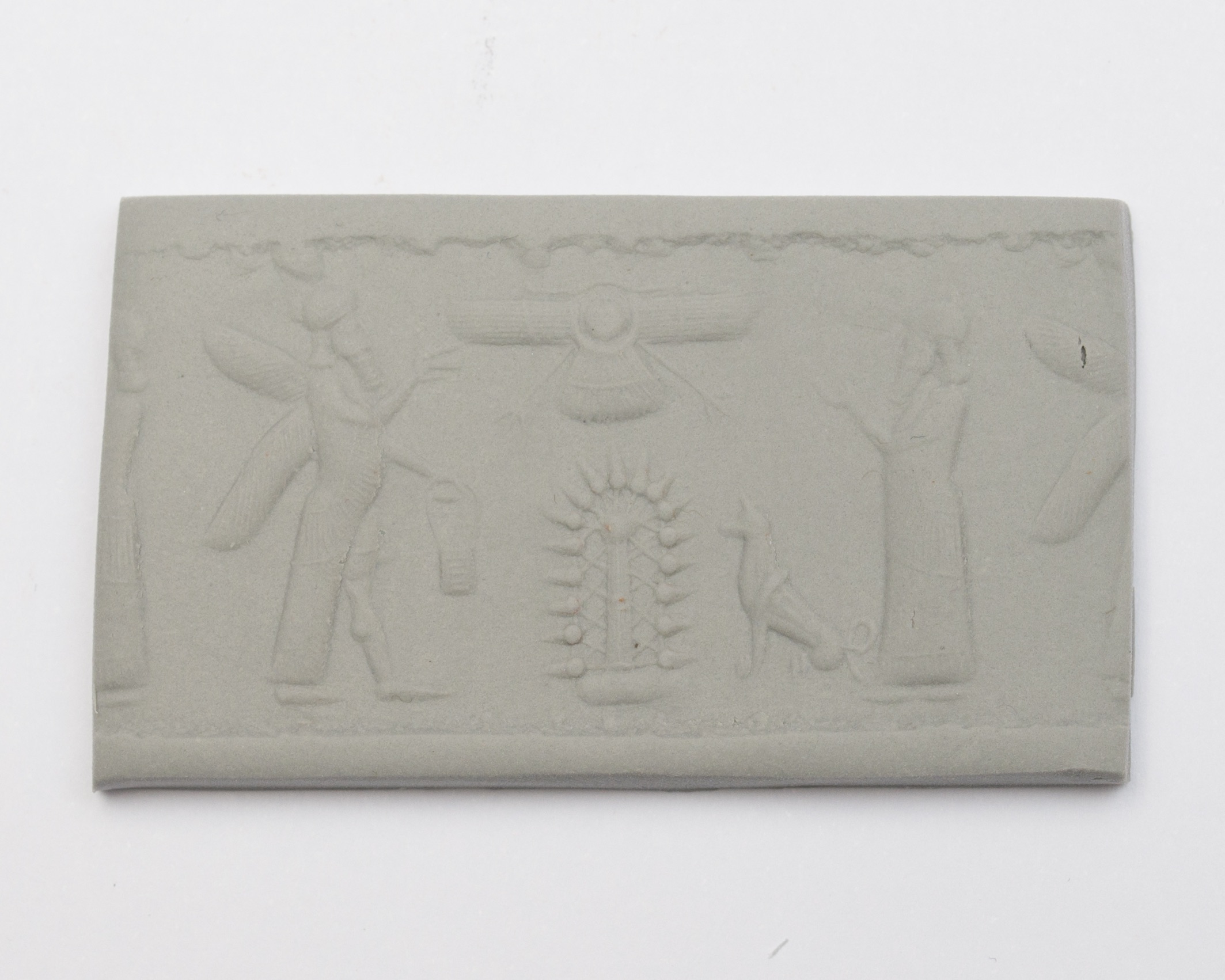 a seal impression set in a piece of clay, featuring two figures and a dog