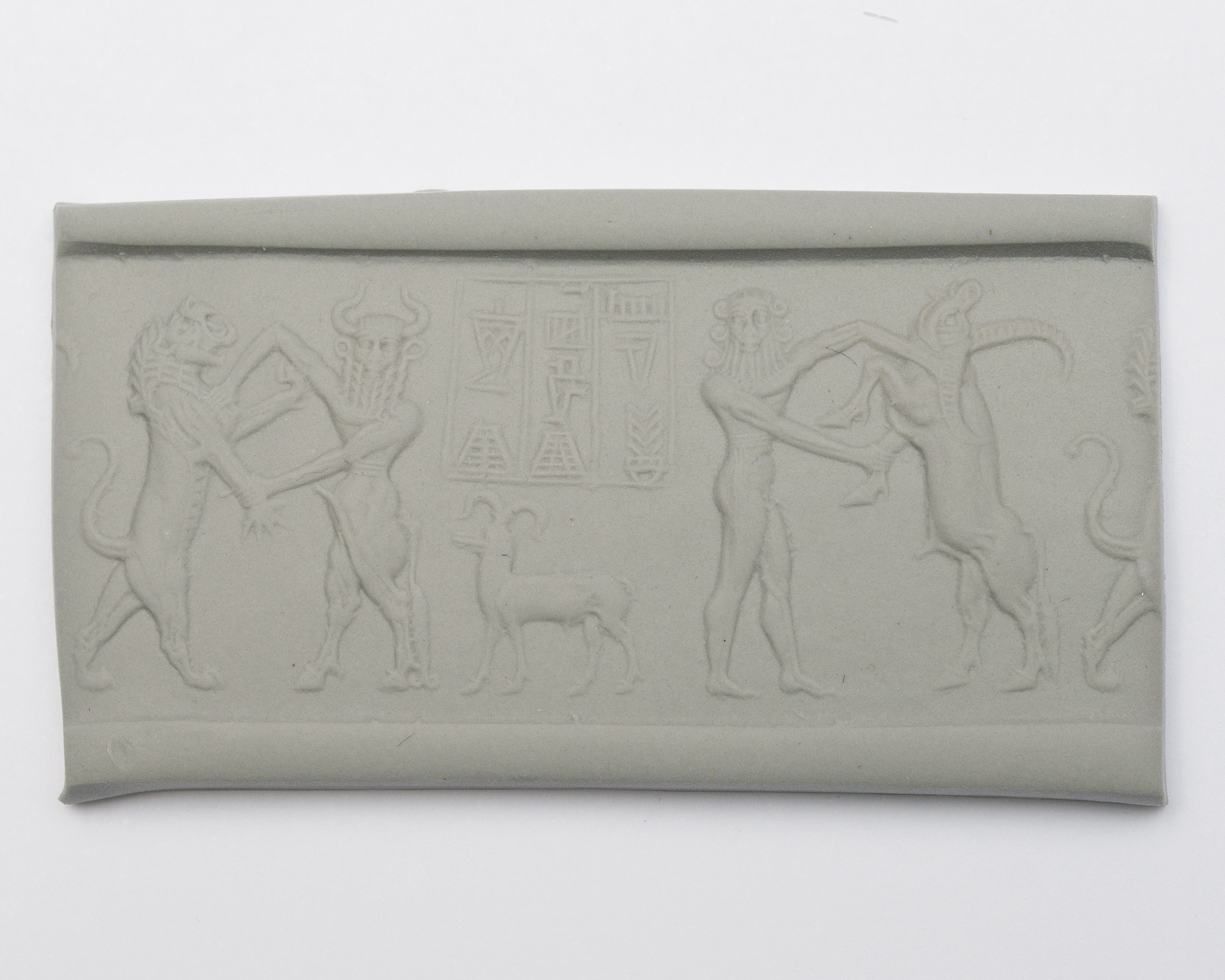 a seal impression set in a piece of clay, featuring two humanoid figures wrestling with animals