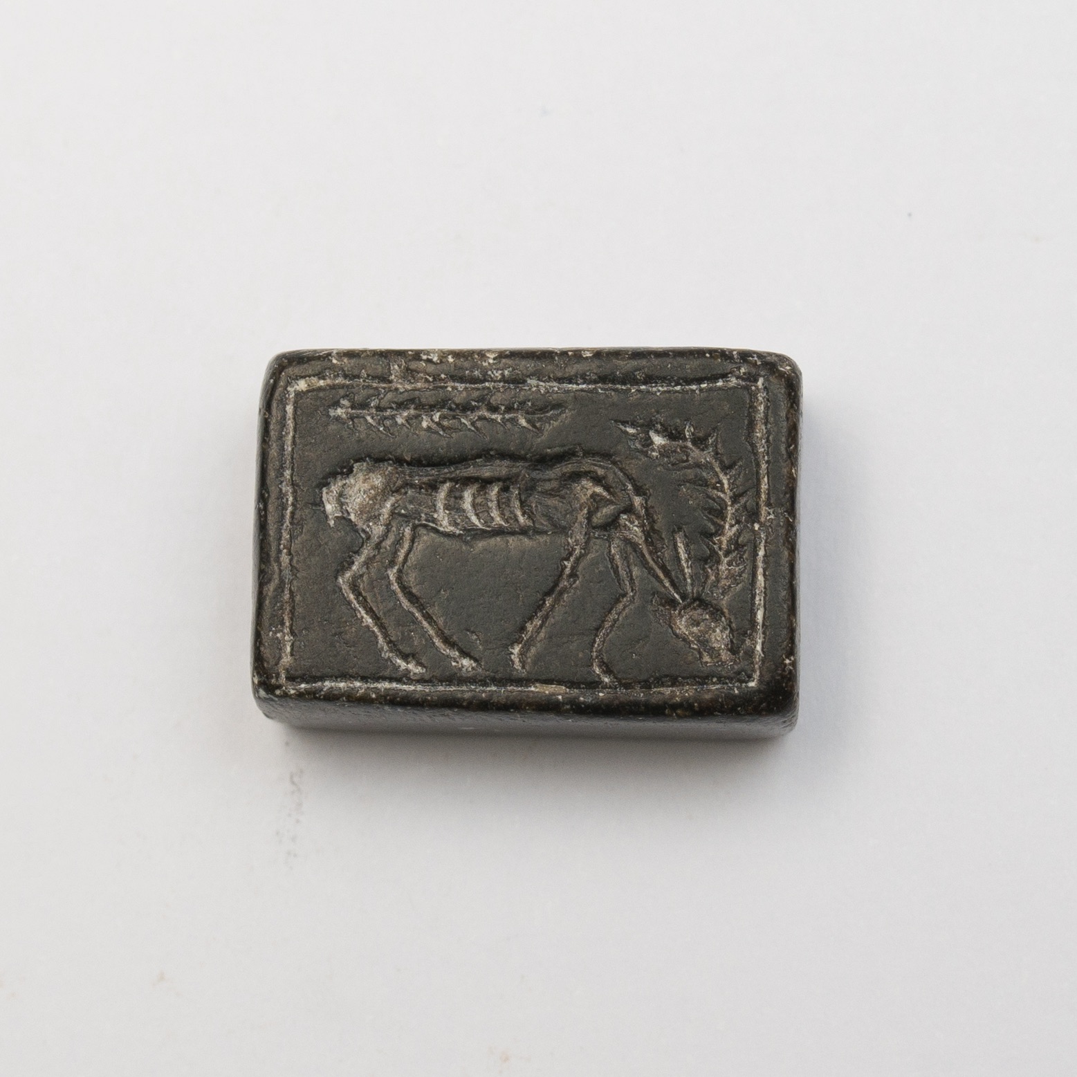 a rectangular seal featuring the image of a grazing animal