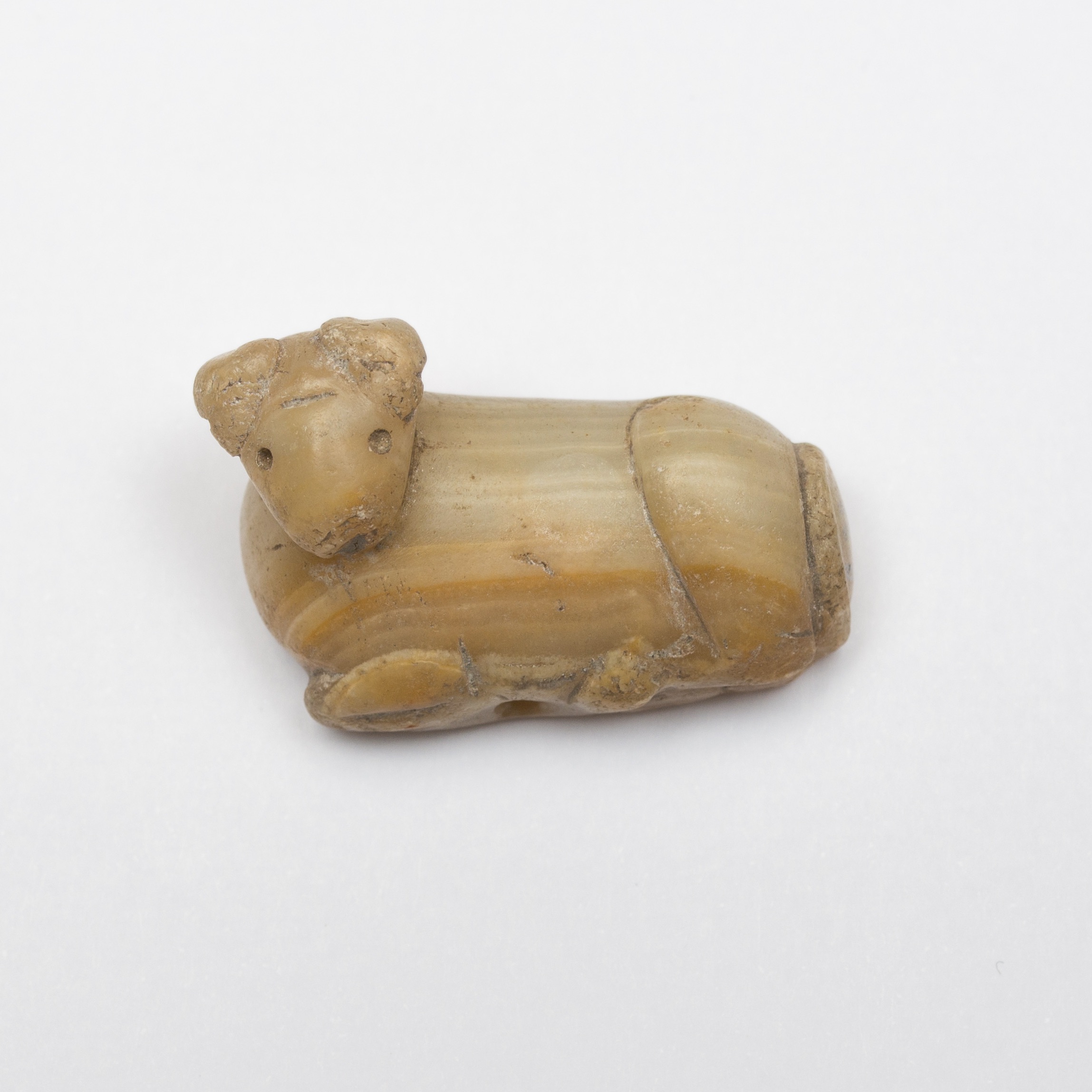 a small yellow stamp seal in the shape of a woodland creature