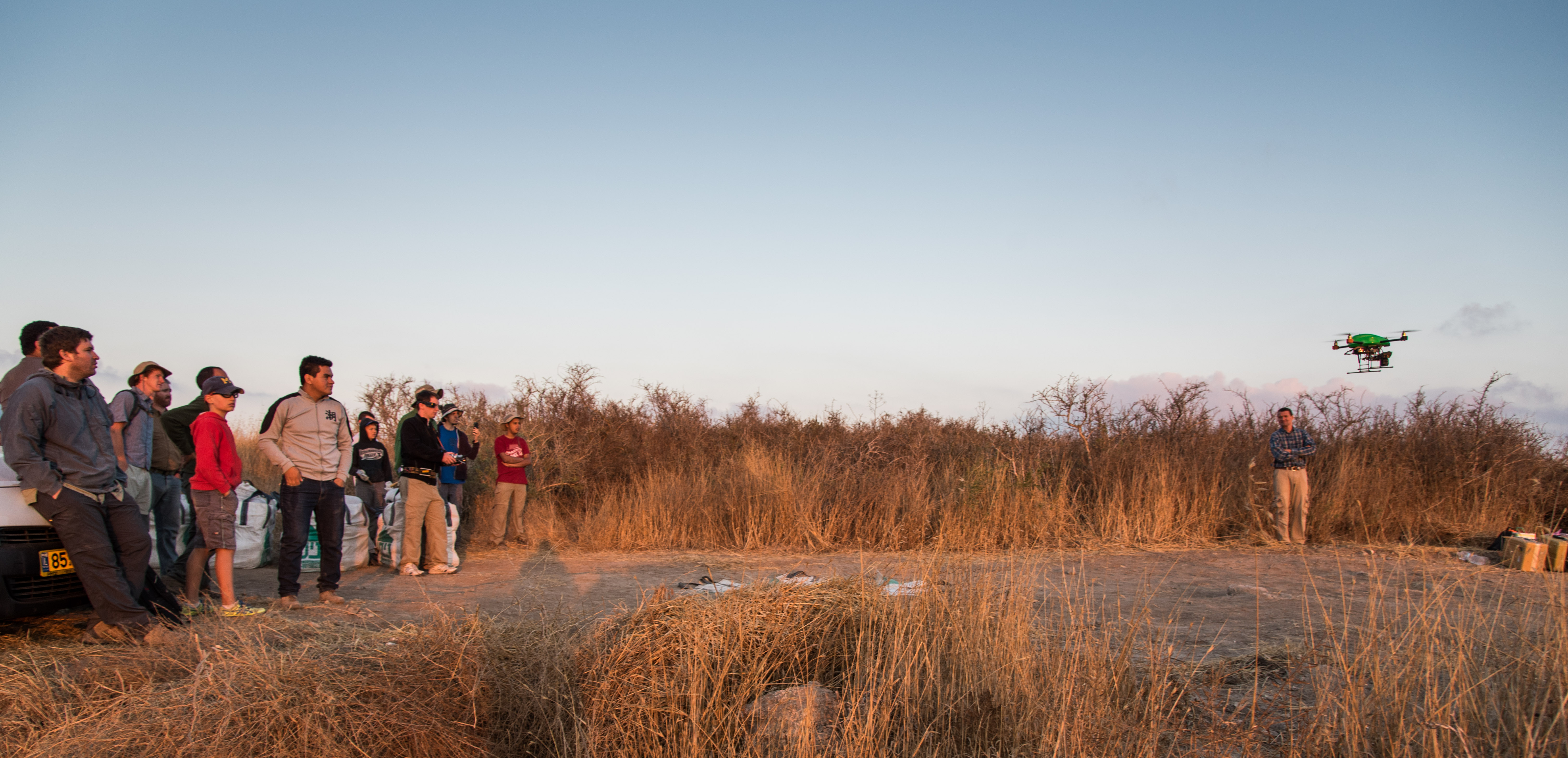 people watching a drone