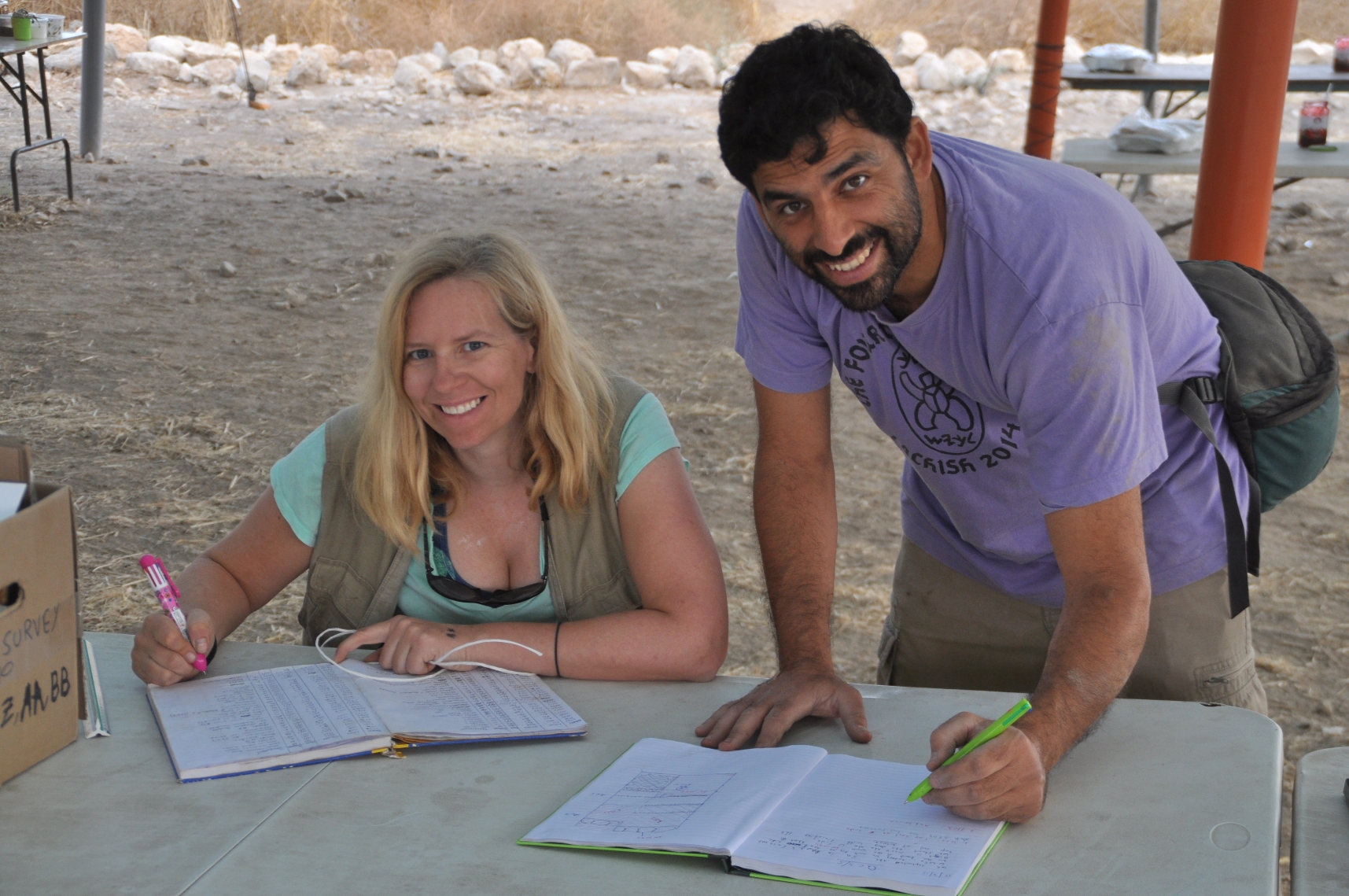 two people writing and smiling