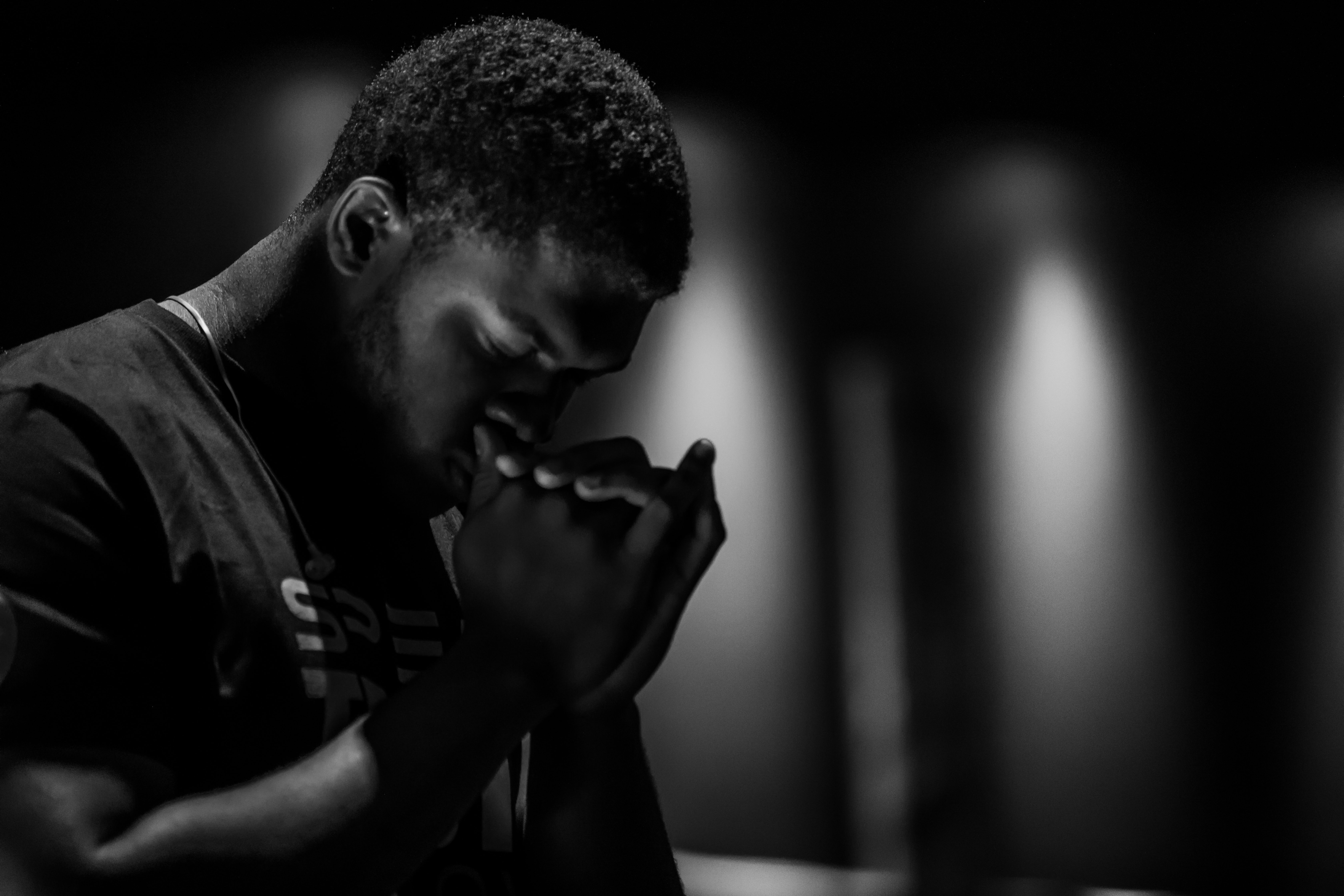 Man with hands folded in prayer