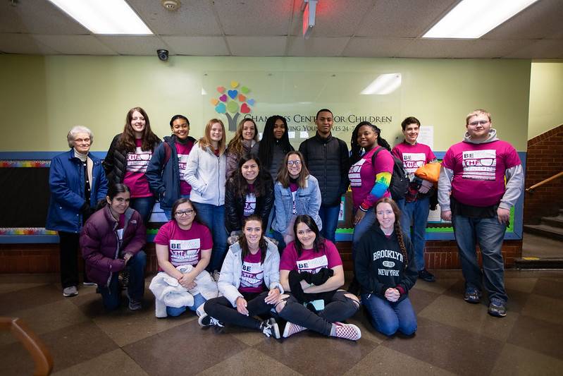 homeless man holding a volunteer's hand