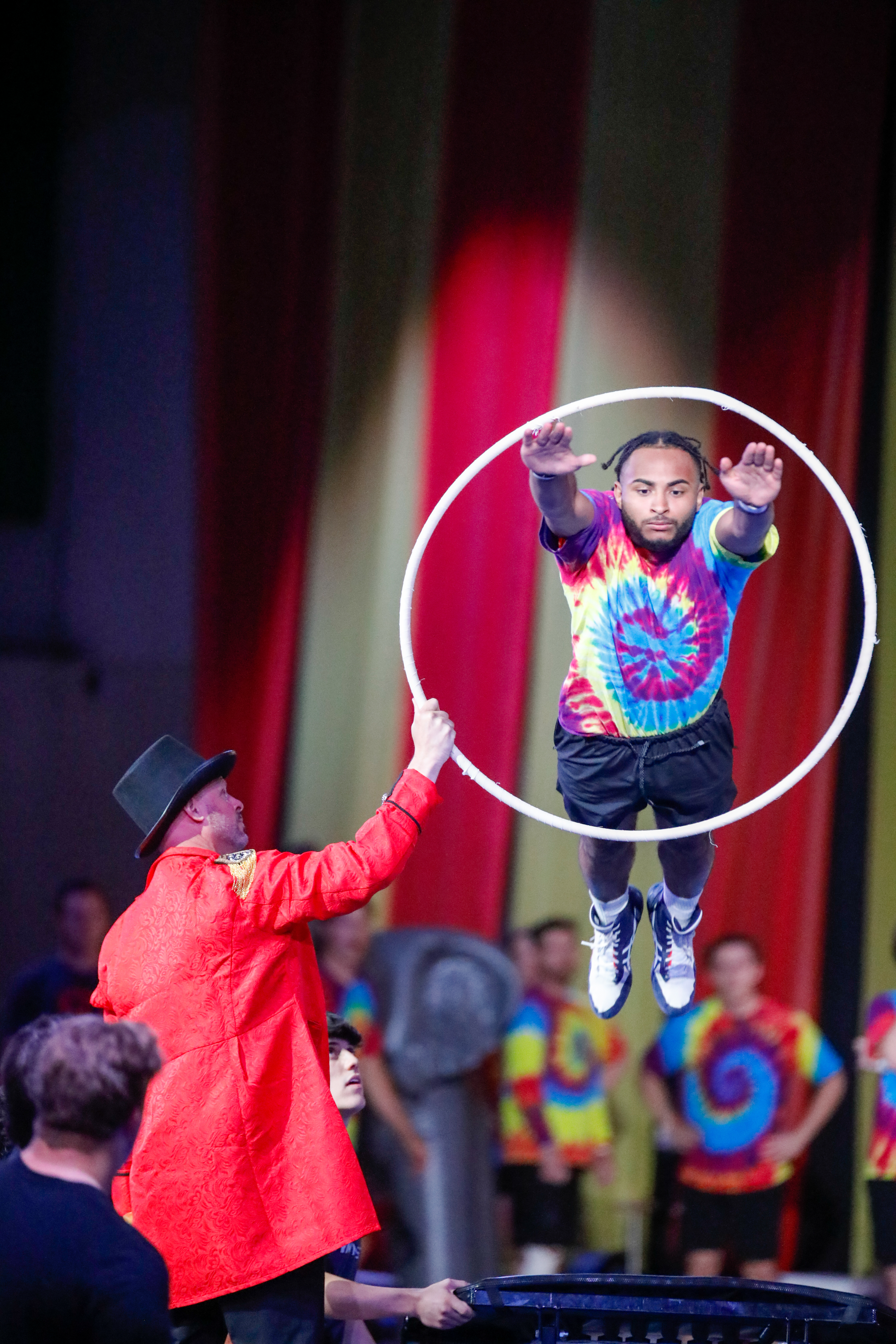 A Gym-Masters member jumps through a hula hoop.