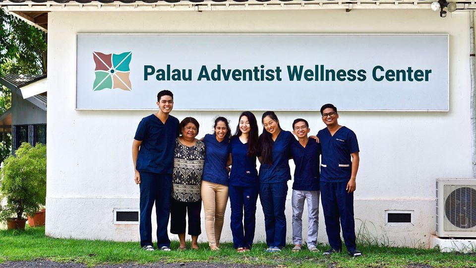 People standing in front of a sign