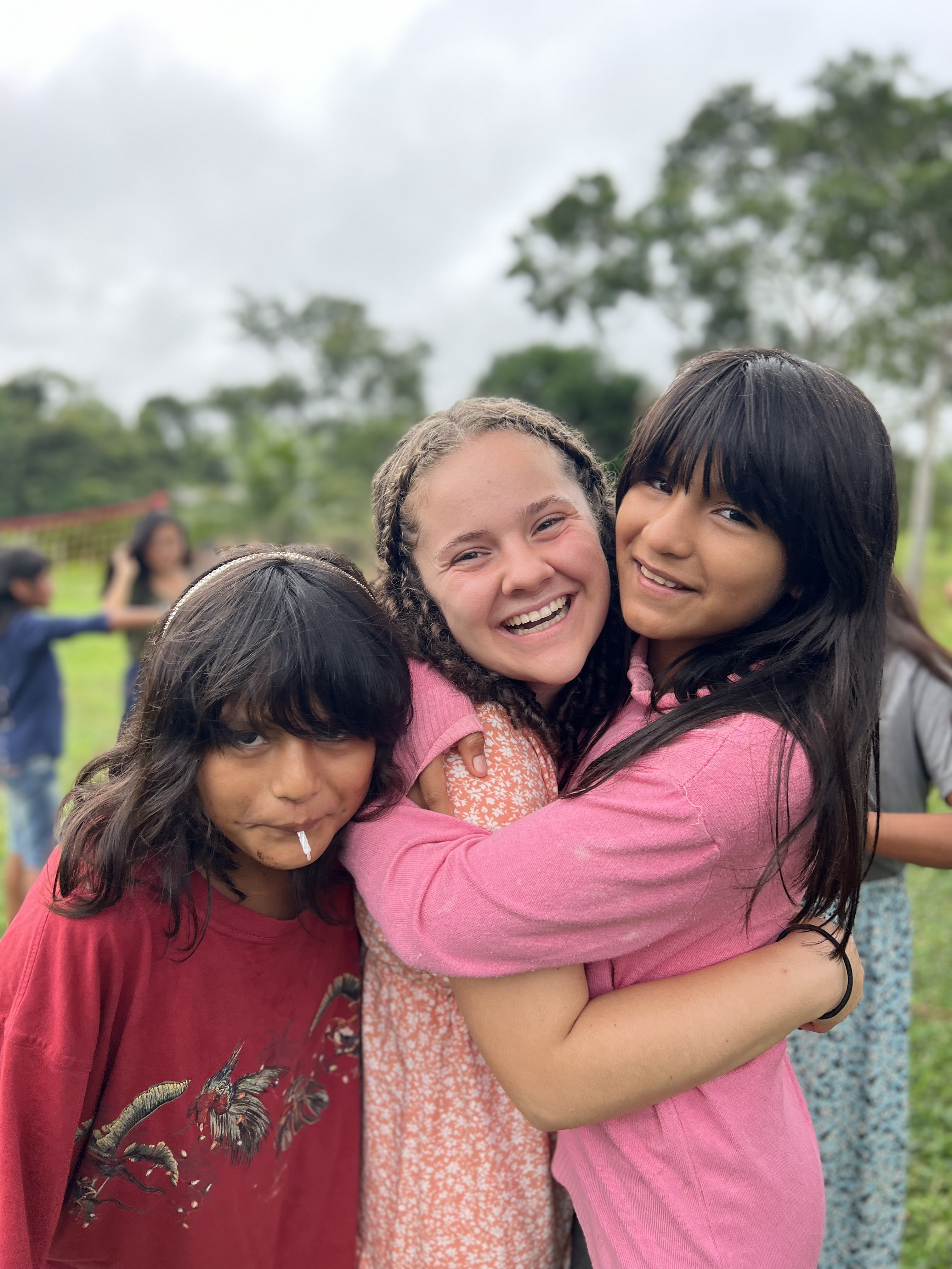 Elizabeth Cannon hugging two younger girls.