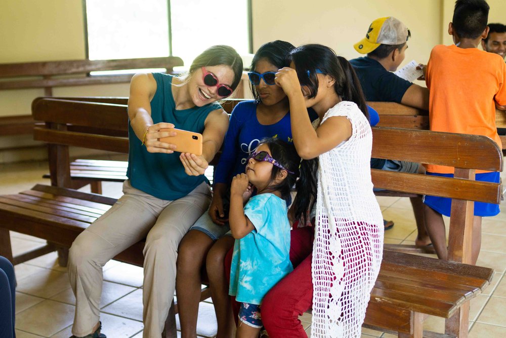 SM Emiliane taking a selfie with some kids.