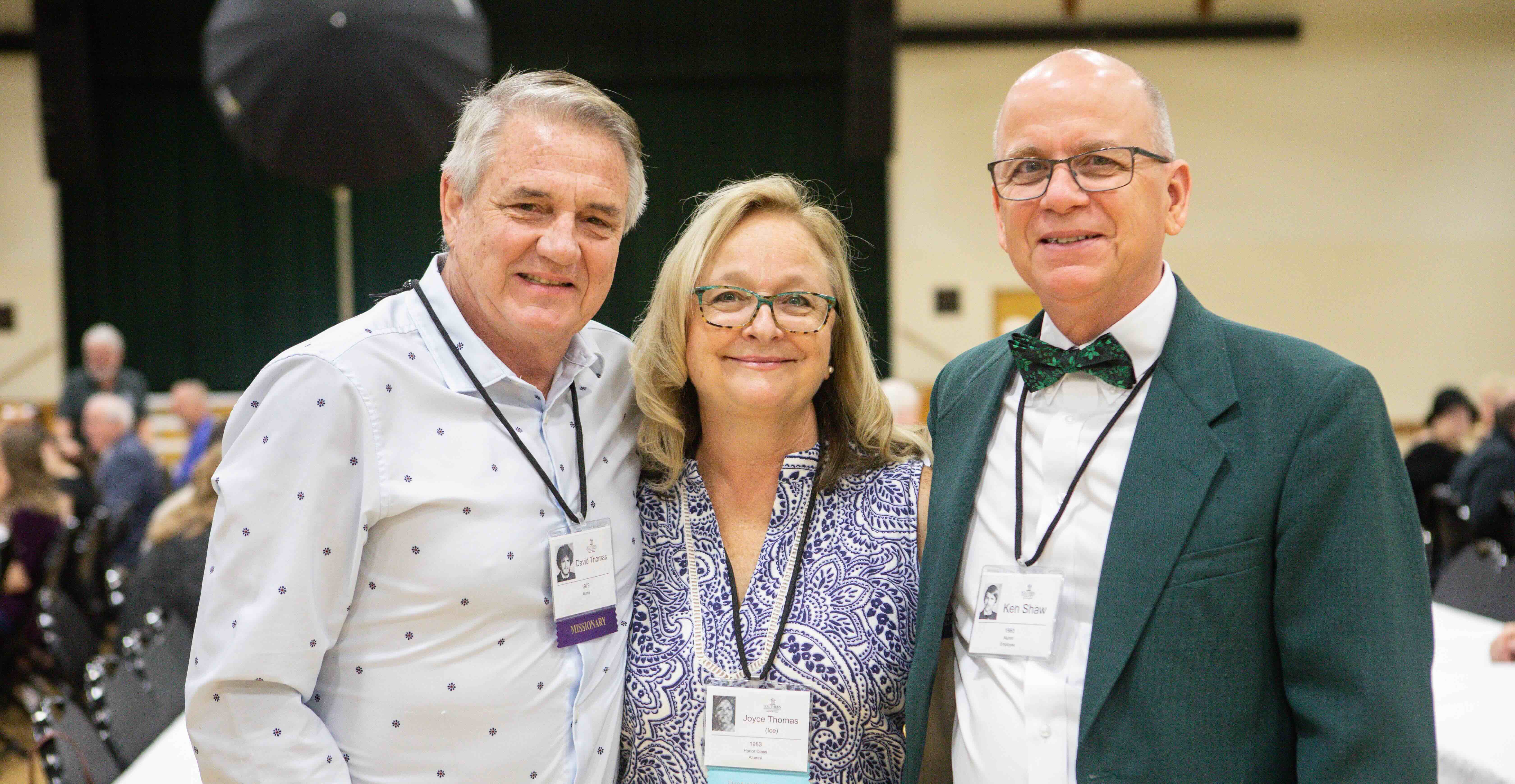 three people smiling for a photo
