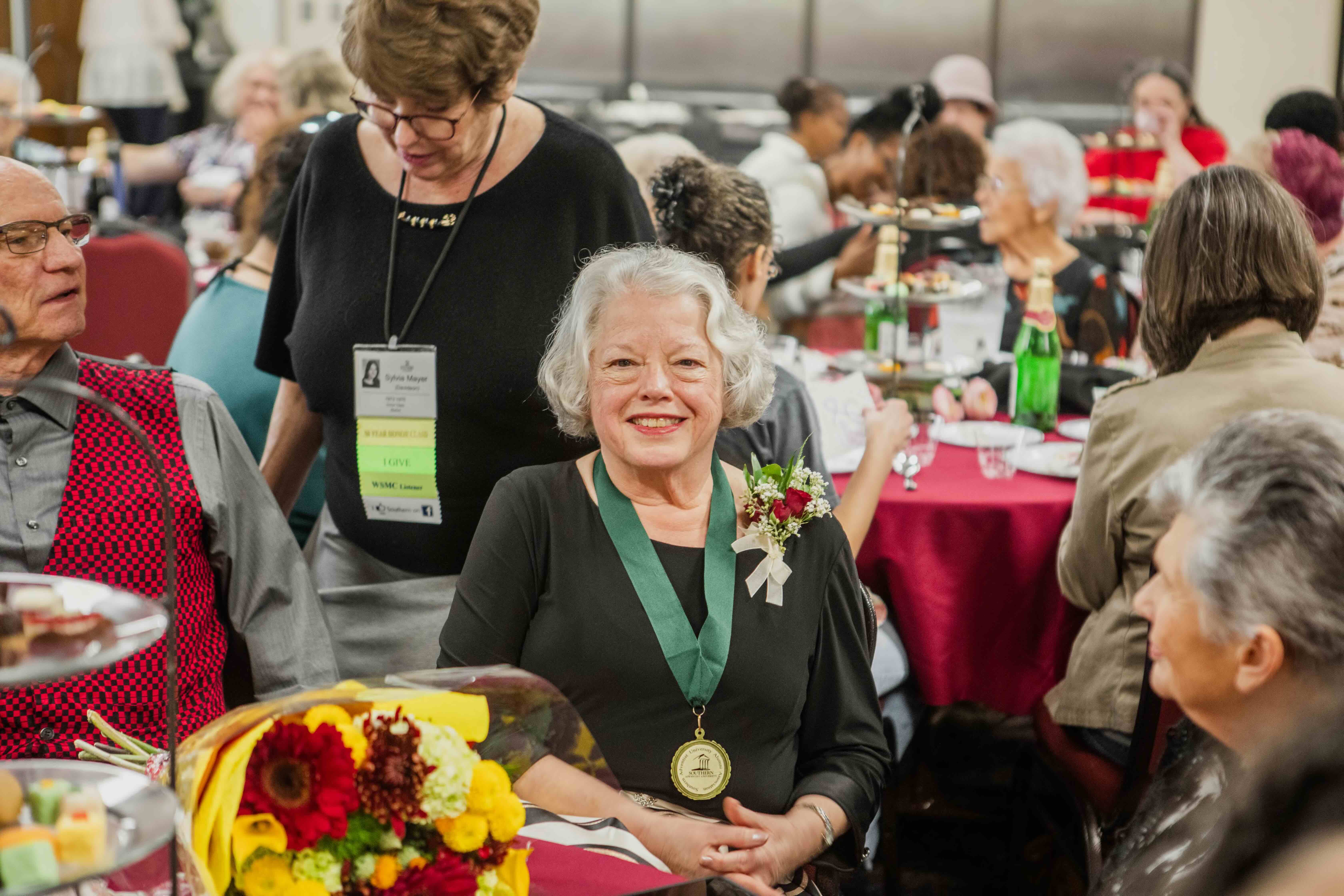 someone smiling with an award