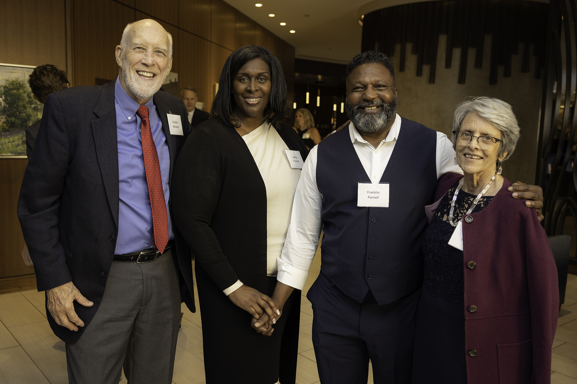 four people smiling for a photo