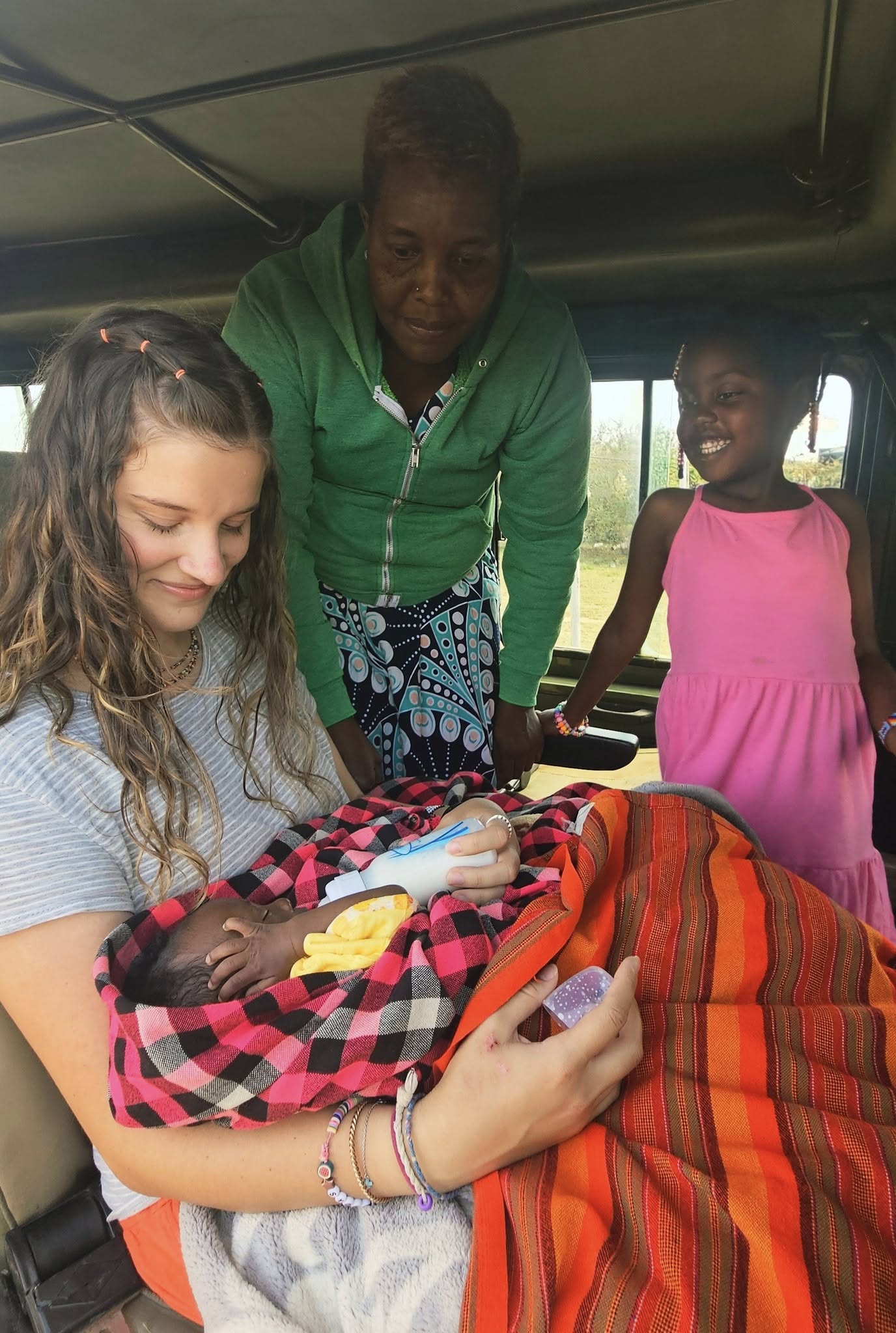 Student missionary holds a baby