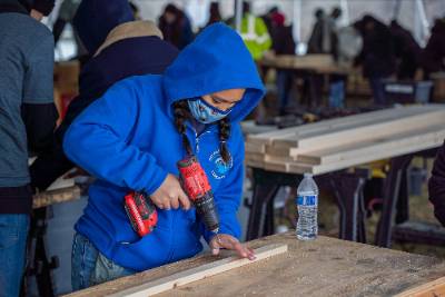 A woman using carpentry tools