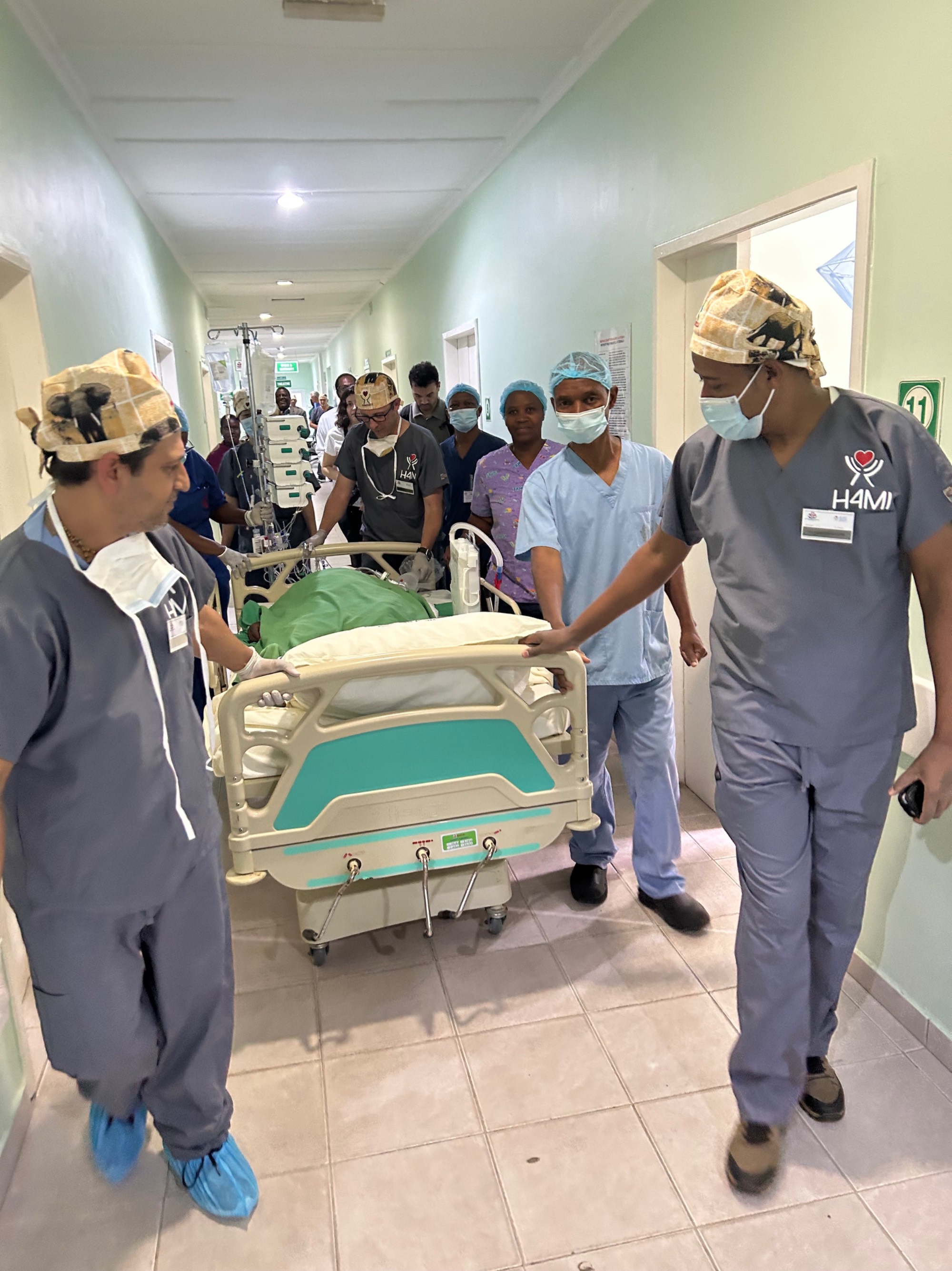 Doctors wheel a patient down a hospital hallway