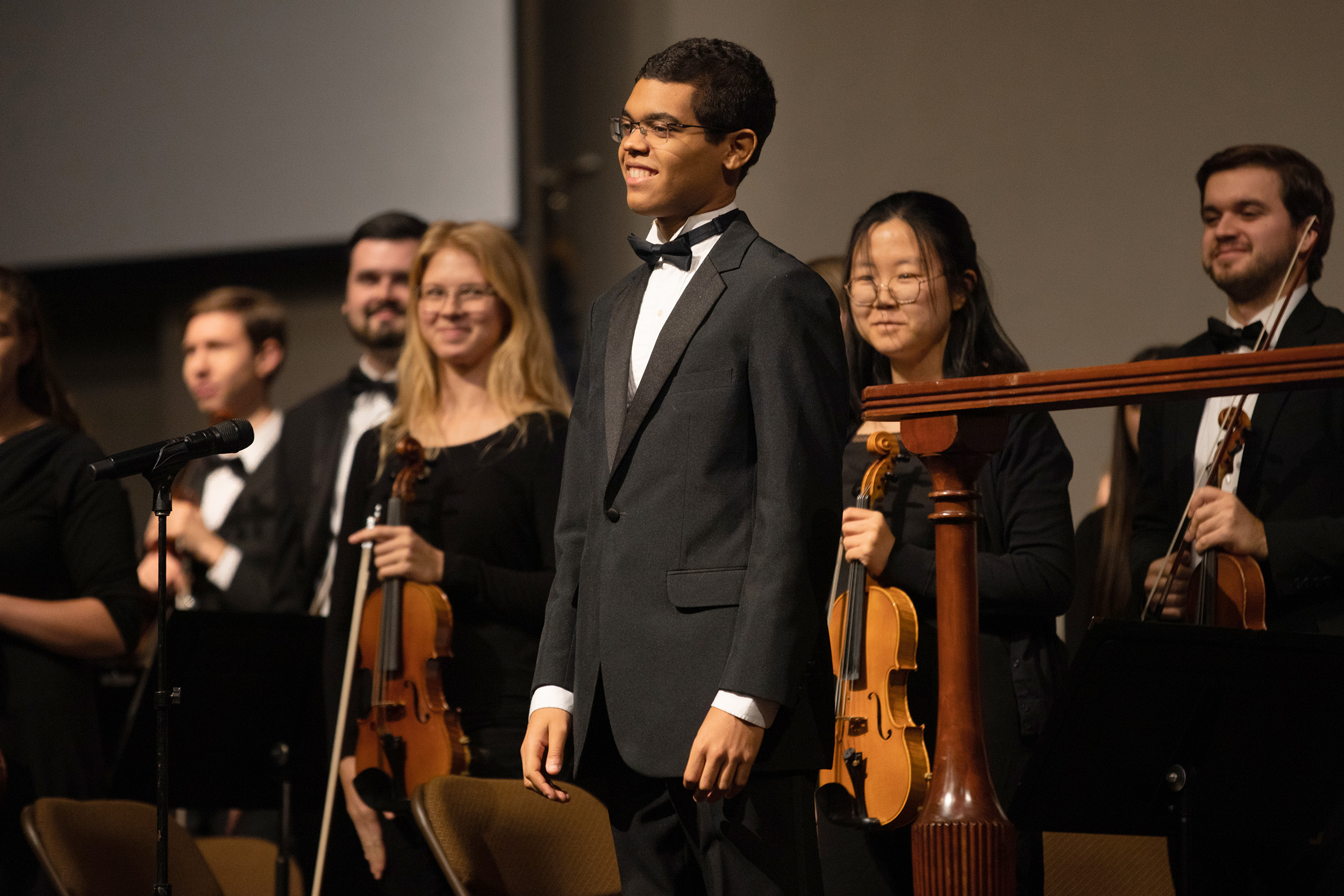 Orchestra leader smiling