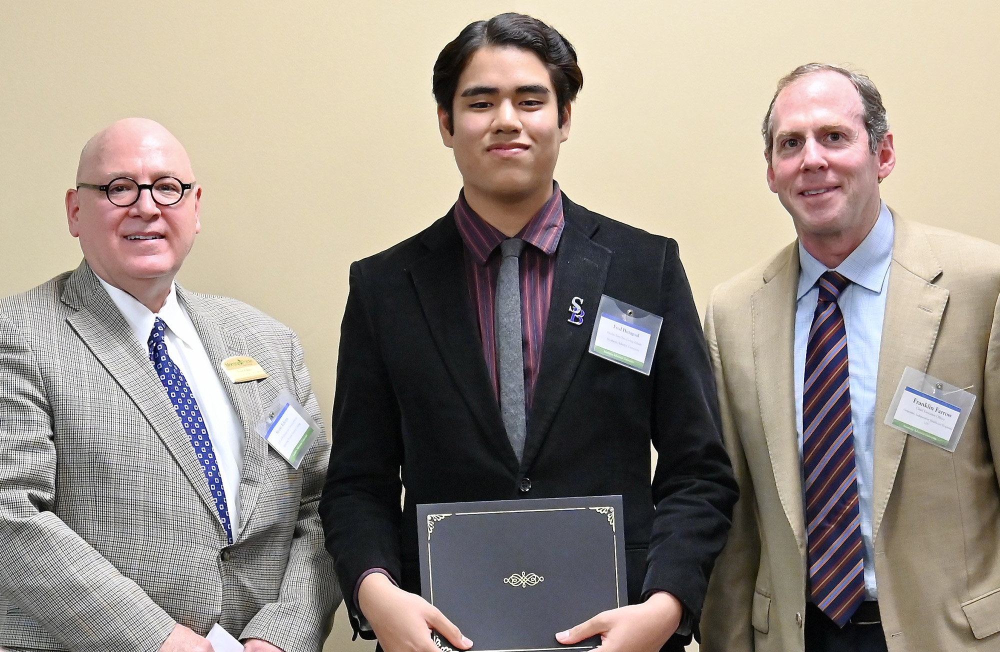 Southern student Fred Hutagaol (center) is presented with the scholarship by Morning Point administrators Franklin Farrow (right), co-founder and chief executive officer, and Scott Edens (left), vice president for professional development.