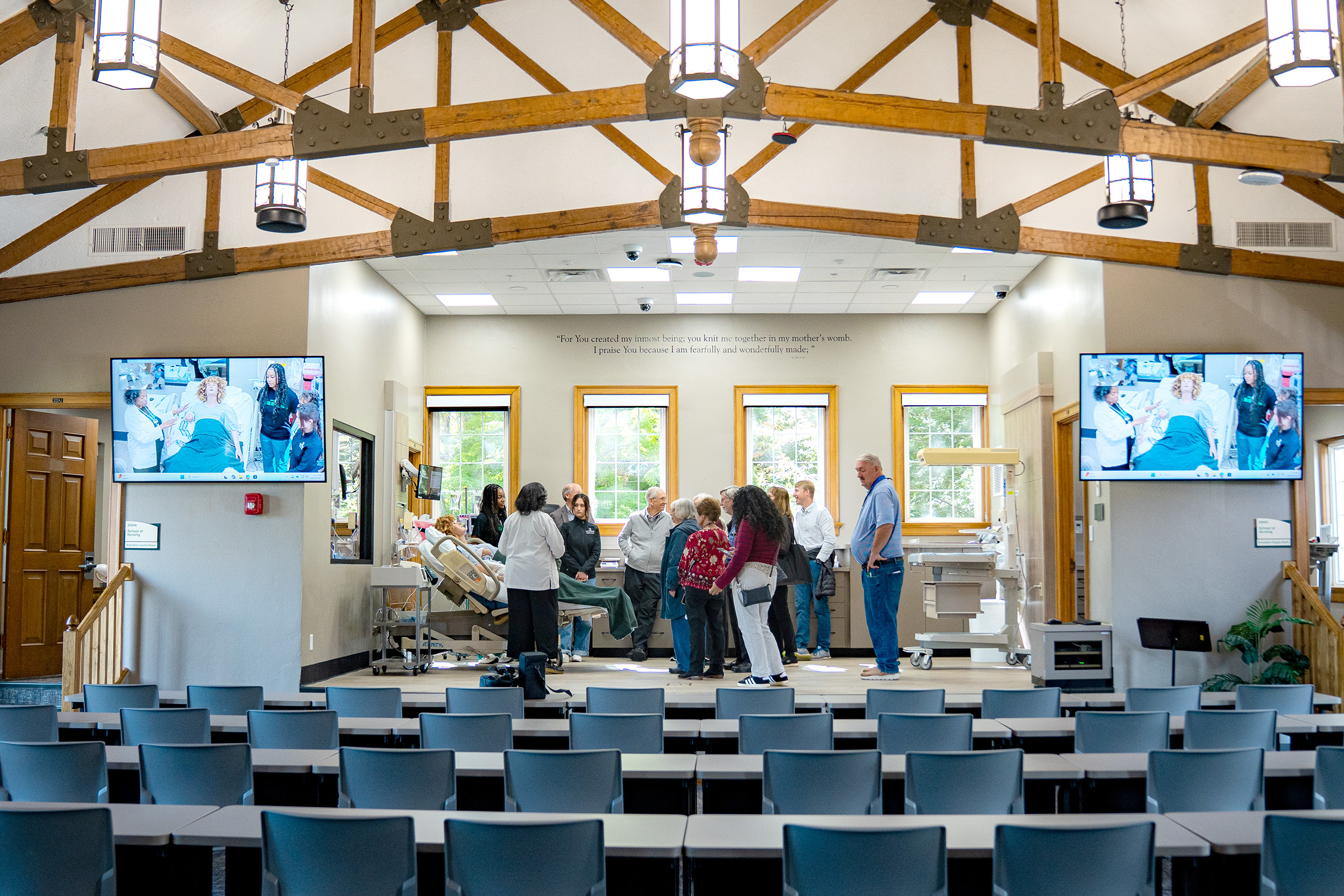 Alumni and visitors tour the Miller Hall Simulation Center during the grand opening.